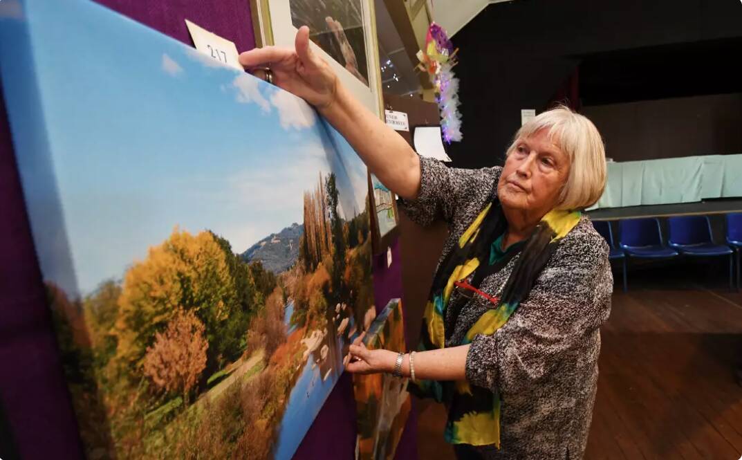Margaret Hemmings helps with hanging entries for a recent Bendemeer Art Show. Picture by Gareth Gardner