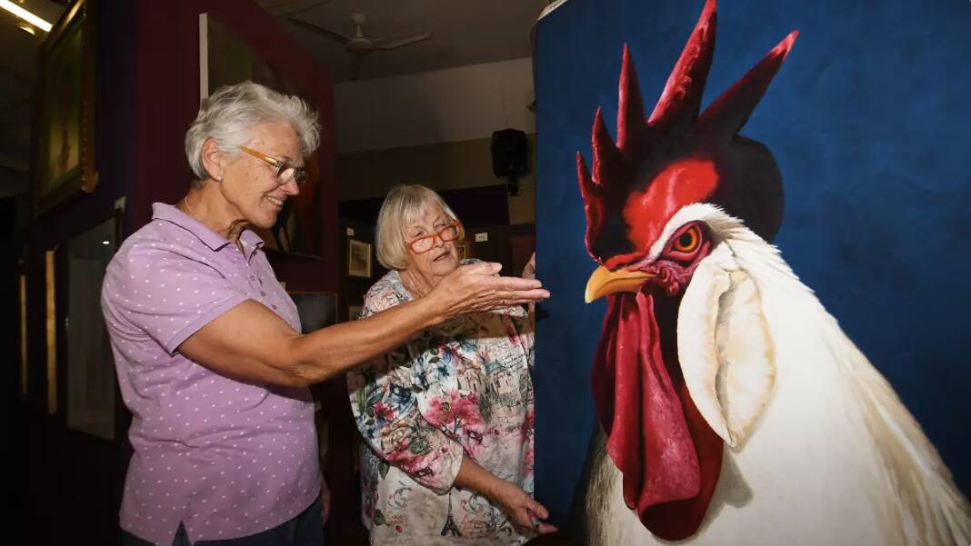 Bendemeer Art Show's Carol-Ann Brown and Margaret Hemmings admire the bold colours of a painting on display during the 2023 art show. Picture by Gareth Gardner