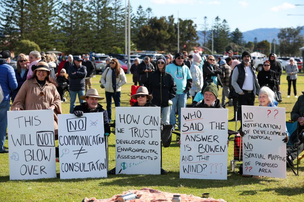 People holding placards at the anti-offshore wind farm rally at Lake Illawarra on July 28. Picture by Adam McLean