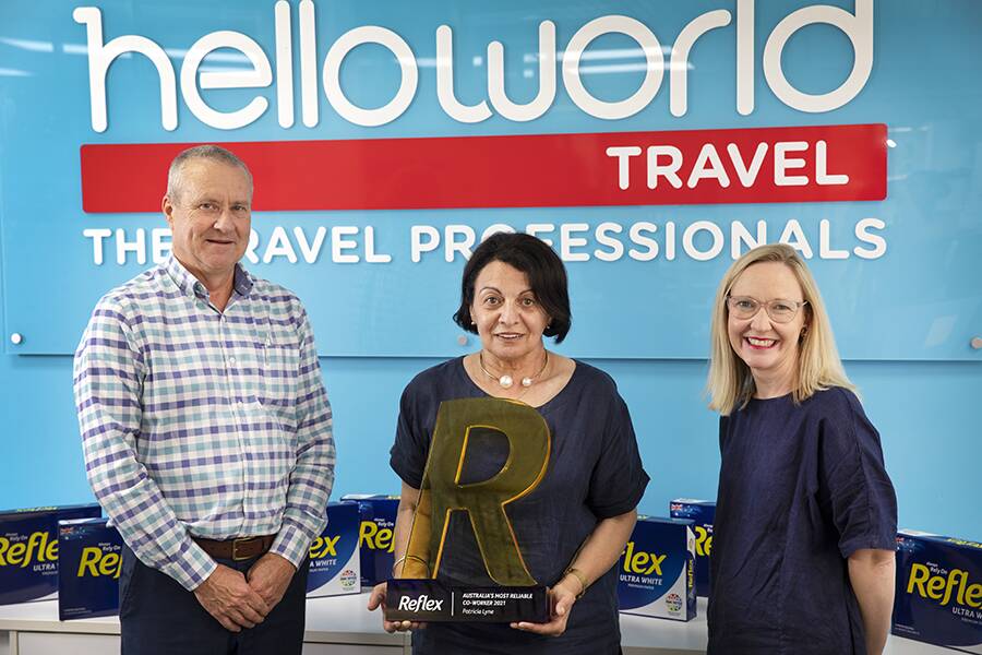 HUMBLE: Phillip and Trish Lynn with Helloworld colleague Emily Crockett celebrate Trish being awarded most reliable co-worker. Photo: Supplied