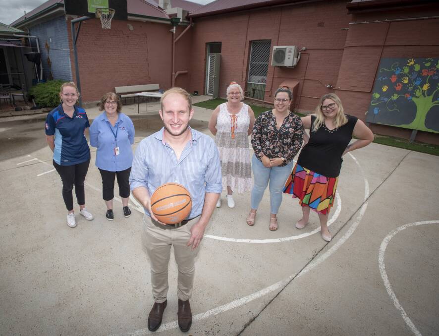 HOOPS: PCYC staff Sharni Towers and Debby Henderson share the court with Headspace staff Sam Davis, Trish Orchard, Lyndell Moffett and Bec Hooper. Photo: Peter Hardin