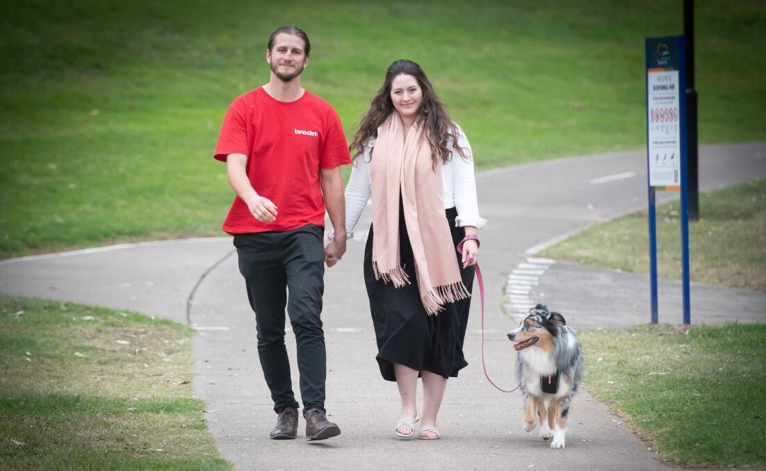 Sam and Emma Lovegrove with Australian Shepherd Maddie, who went missing for six weeks in East Tamworth. Picture by Peter Hardin