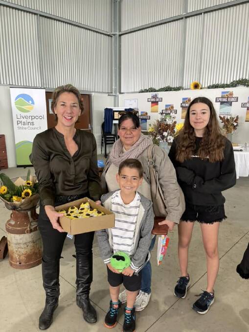 Liverpool Plains Shire Council general manager Jo Sangster hands out sunflower cupcakes to community members. Picture by LPSC