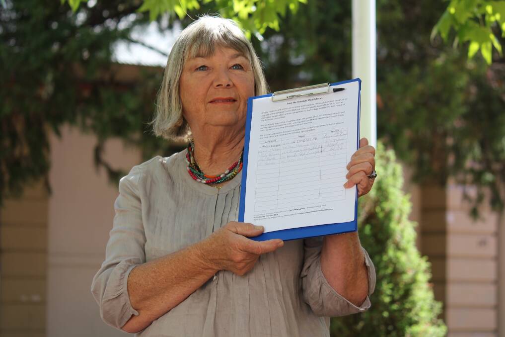 Armidale resident Maria Hitchcock, pictured with a different petition, has been a prominent local to support a petition to break up the district. Picture from file