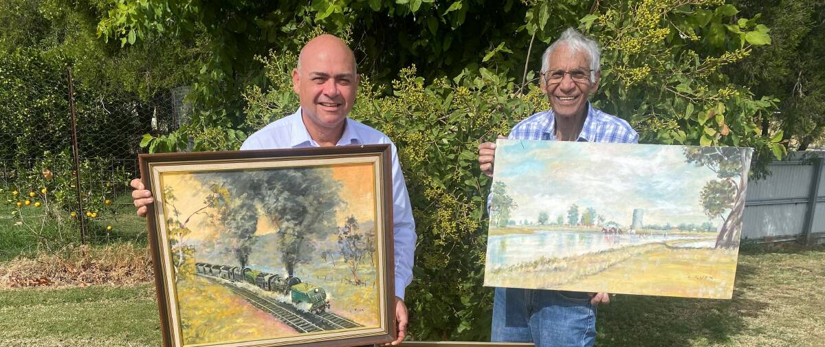 Whitehaven manager of Aboriginal community relations Bob Sutherland and son of renowned artist Cyril Knox, Les Knox, hold examples of the artists'a work. Picture supplied