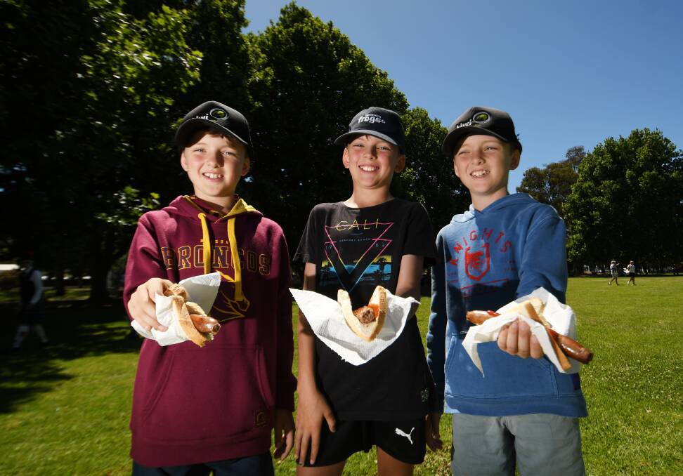 Conor, Colby and Bryson Unger enjoyed the sausage sizzle. Picture by Gareth Gardener