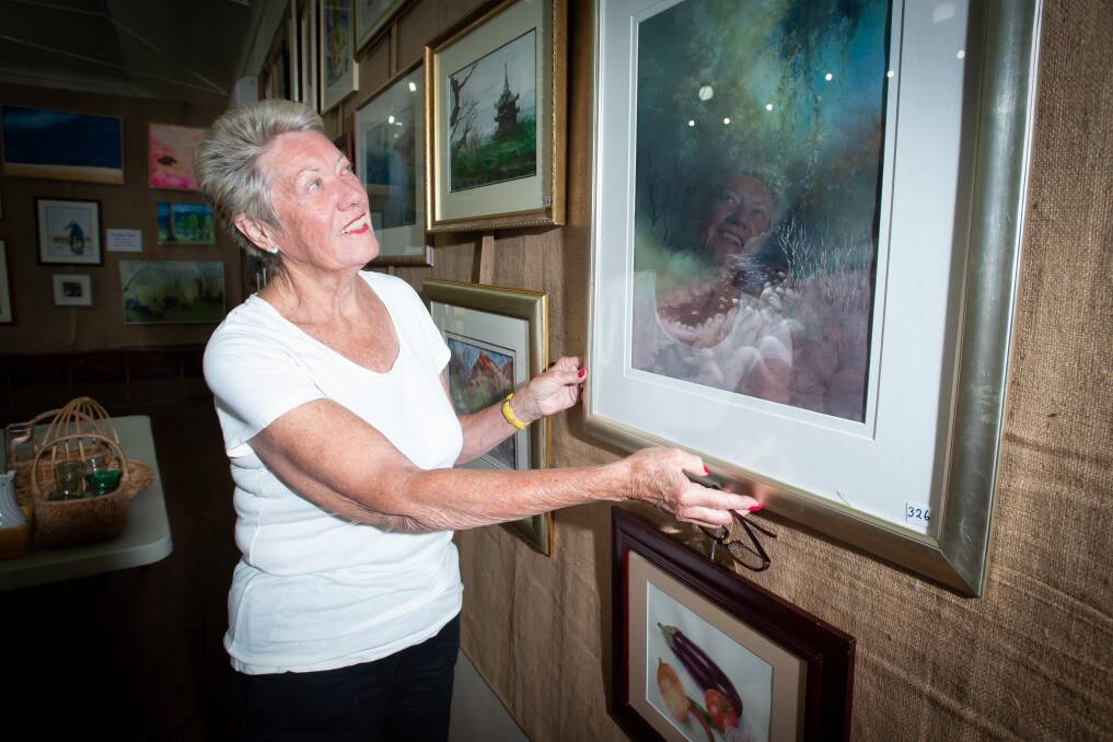 Margaret Schofield putting the finishing touches on the exhibition. Picture by Peter Hardin 