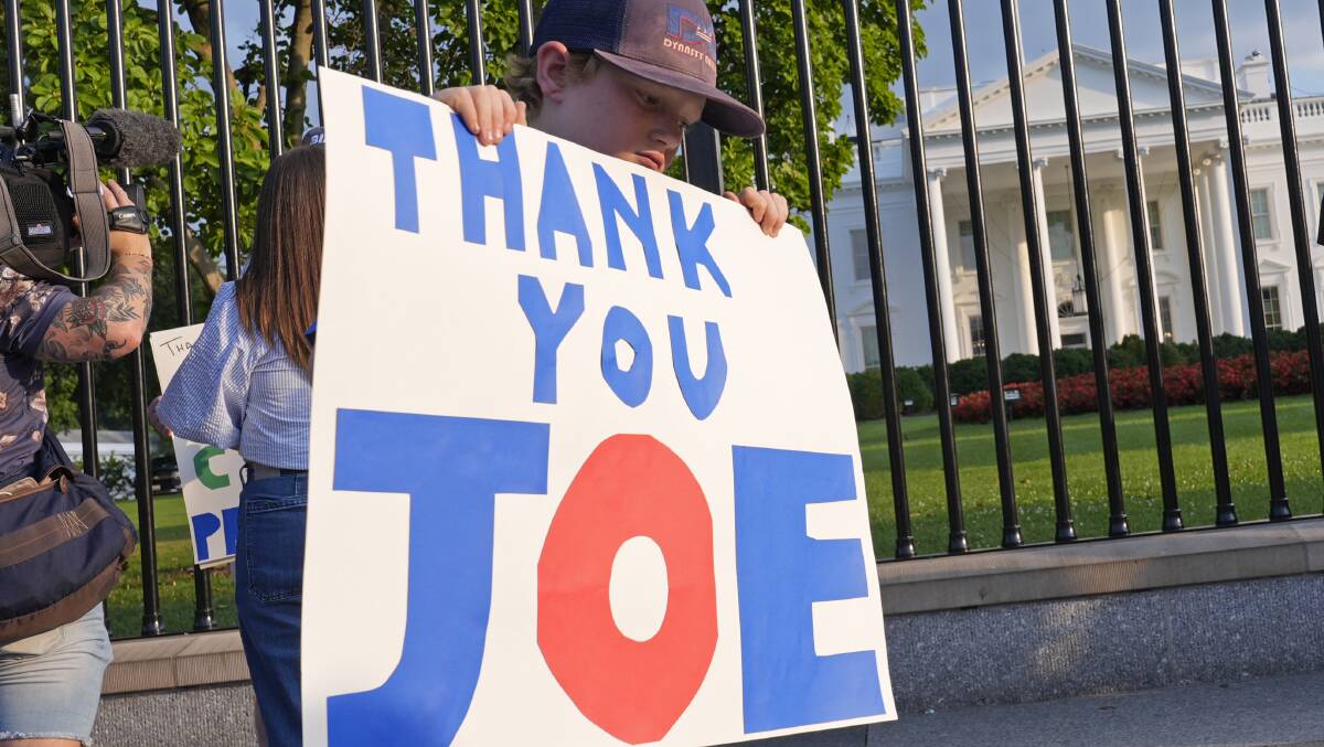 Hugh Kieve, 10, of Washington, holds a sign outside the White House in Washington, Sunday, July 21, 2024. (AP Photo/Susan Walsh) 