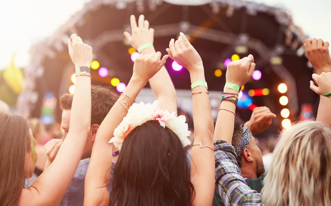 People dancing at a music festival. Picture by Shutterstock