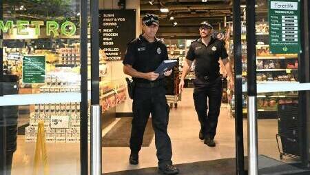 Police at the Woolworths in the Brisbane suburb of Teneriffe after it was graffitied on January 15. Picture via Darren England/AAP PHOTOS