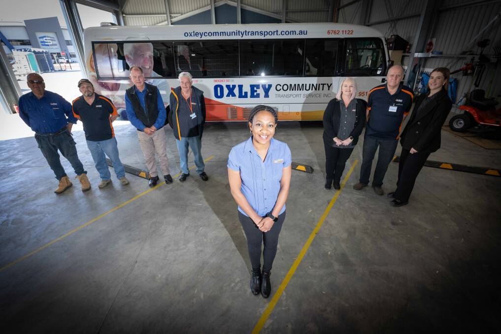 Oxley Community Transport program coordinator Nakita Somerville flanked by a cohort of volunteers who make it their mission to provide company to people in aged care once per week. Picture by Peter Hardin