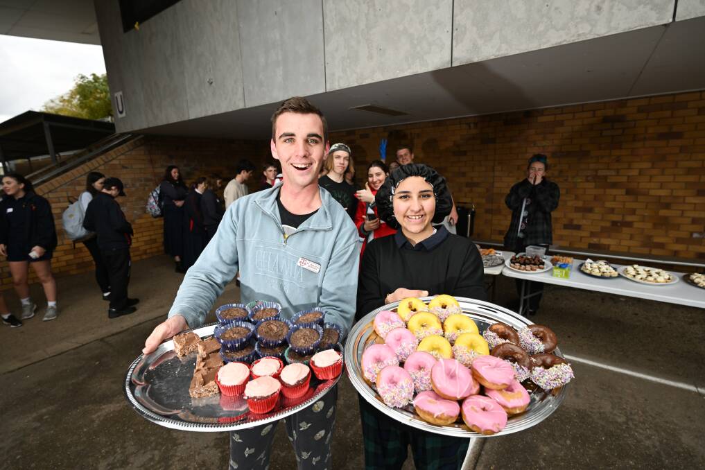 Oxley students Matthew Barratt and Xaina Abdelmaboud helped sell a wide variety of sugary snacks on Thursday to raise money for the Little Wings charity. Picture by Gareth Gardner