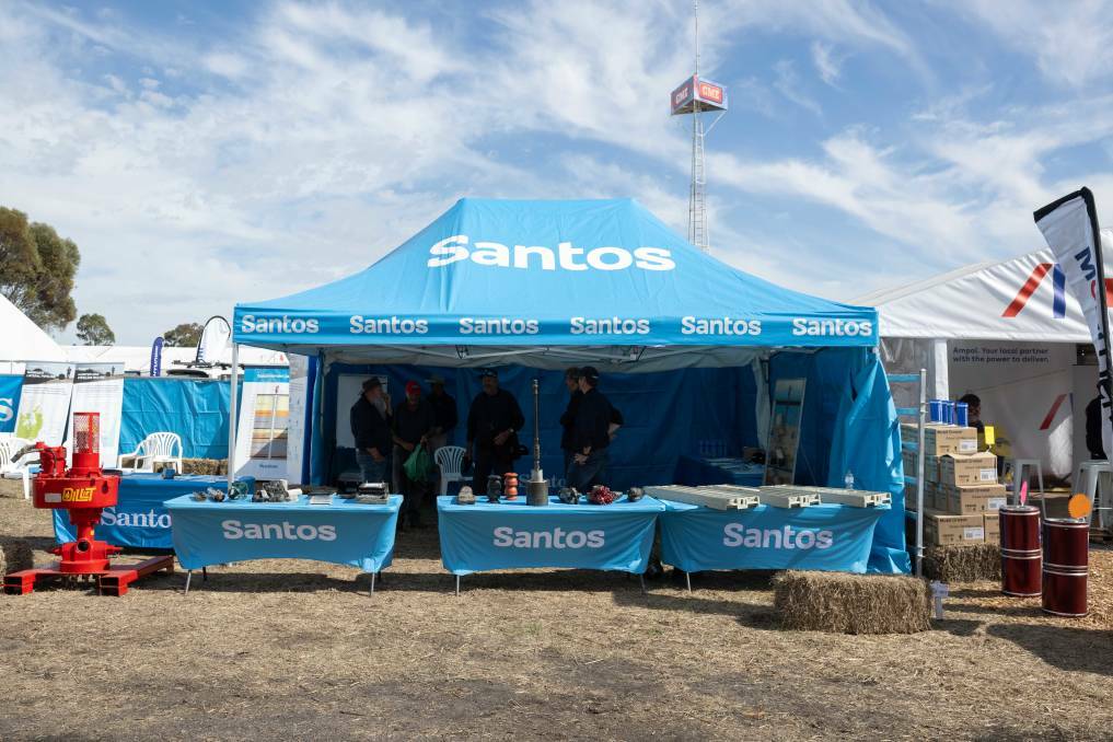 About 200 metres away from where the Liverpool Plains Action Group is sharing information on coal seam gas extraction's potential harm to groundwater resources, Santos has a stall dedicated to discussing the economic benefits of its Narrabri gas pipeline. Picture by Peter Hardin