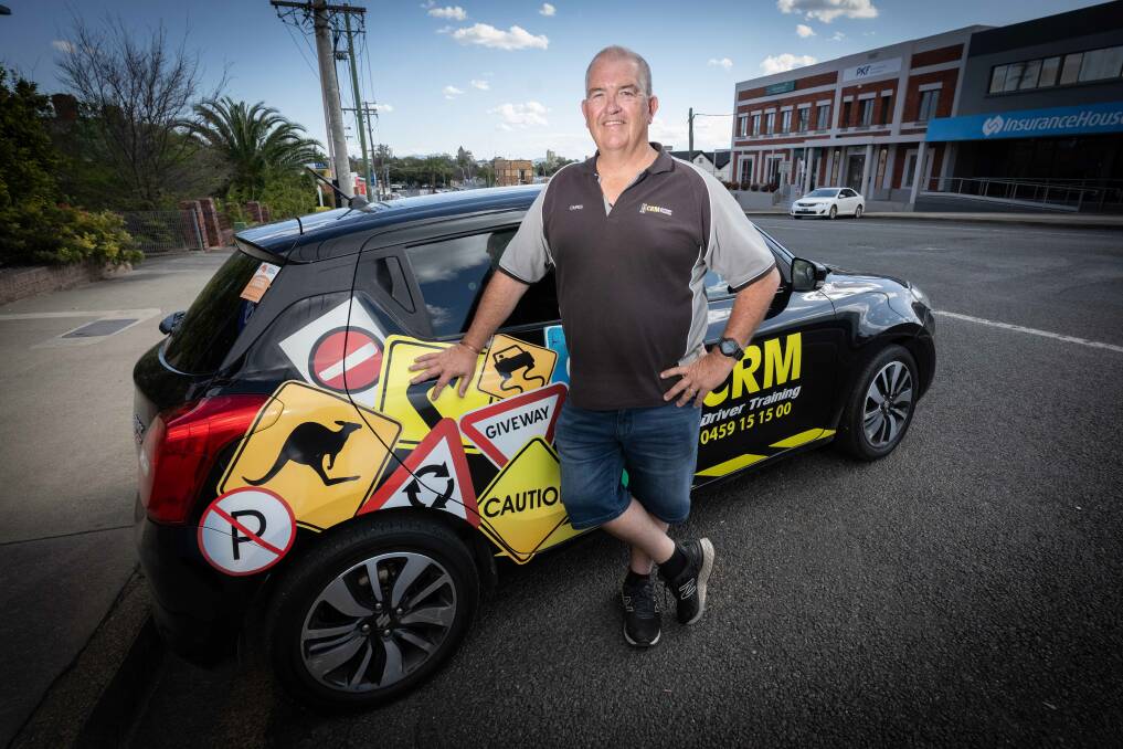 CRM Driving Instructor Chris Maxworthy stands next to his learner driver car, where he has over the years taught thousands of students how to drive. Picture by Peter Hardin. 