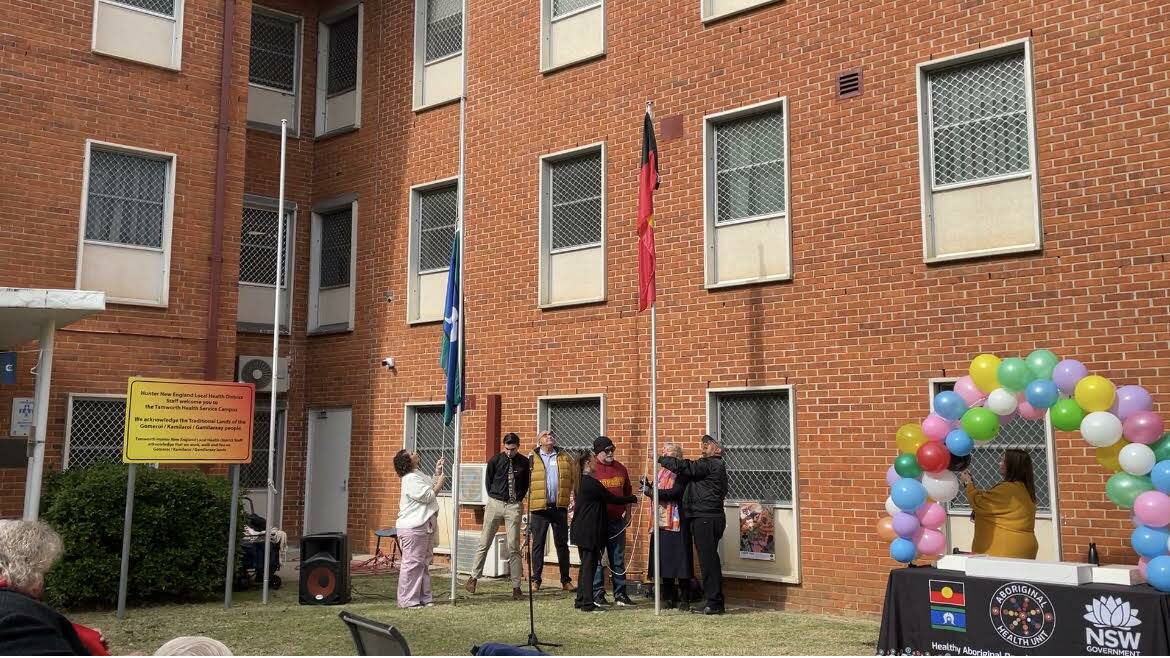 Tamworth hospital Community Health Services raises the Torres Strait Islander and Aboriginal flag. Picture NDL/ACM