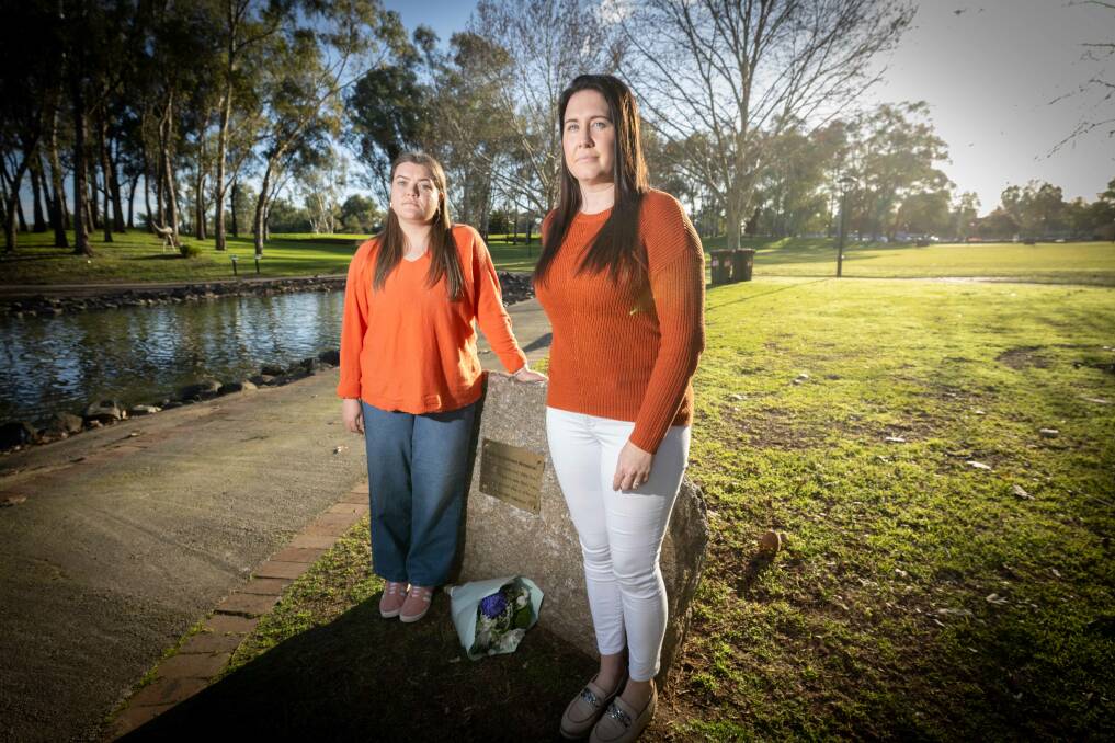 What Were You Wearing? volunteer Madi Cooper and Tamworth rally organiser Tara Grant stand the domestic violence victims remembrance rock at Bicentennial Park. Picture by Peter Hardin