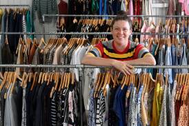 Store manager Emily Honess amongst racks of donated clothing, both second hand and vintage, that is sold at the Talking Threads store on Peel Street. Picture by Gareth Gardner