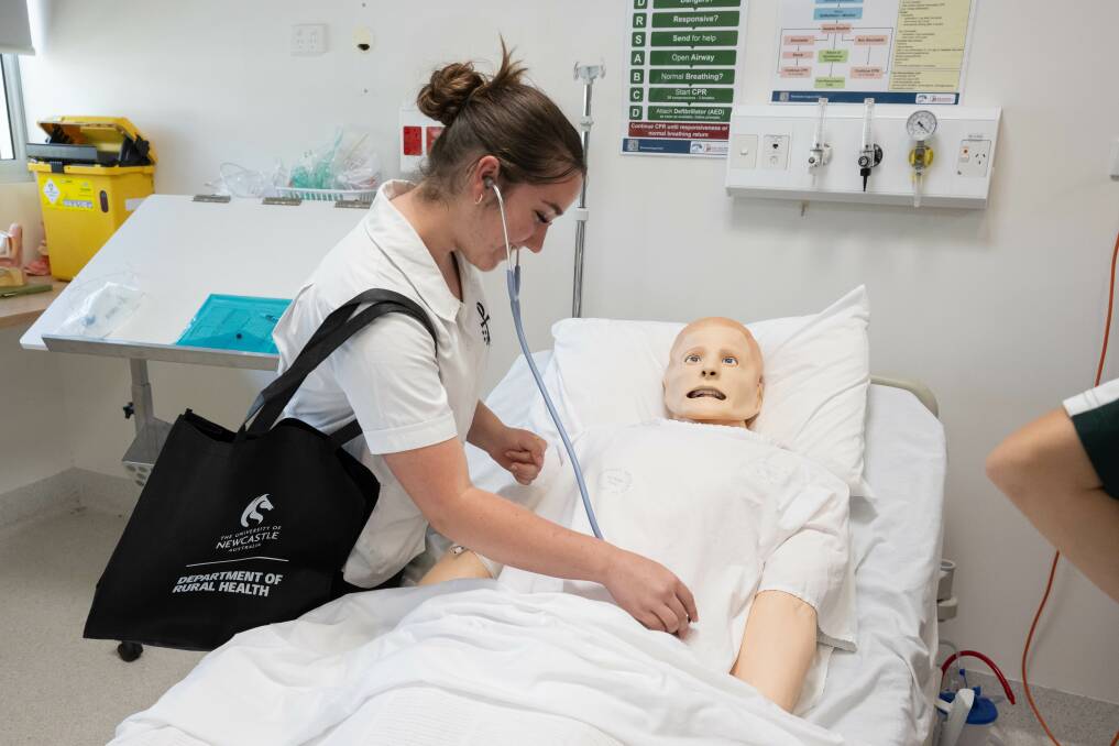 A student works with a practice dummy at the University of Newcastle clinic. Picture by Peter Hardin
