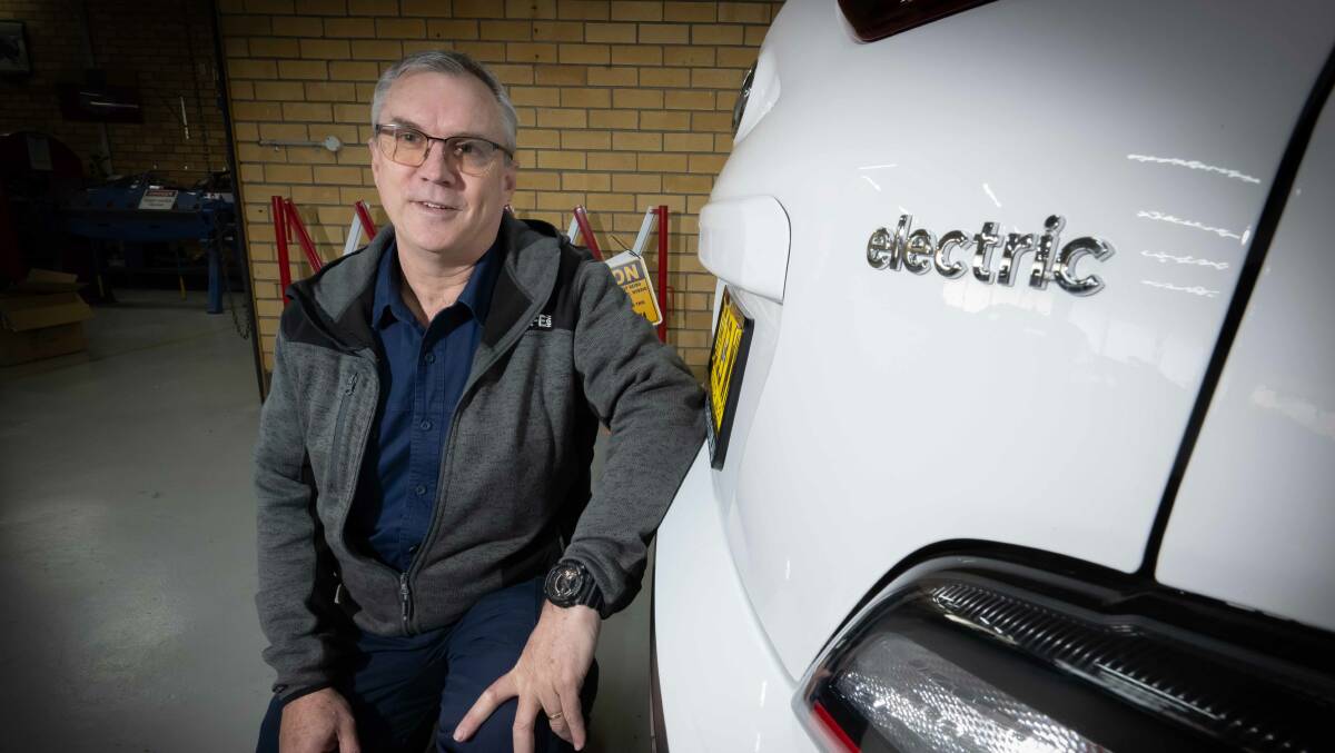 TAFE NSW Automotive Head Teacher Noel Woodbury next to one of their practice electric cars. Picture by Peter Hardin