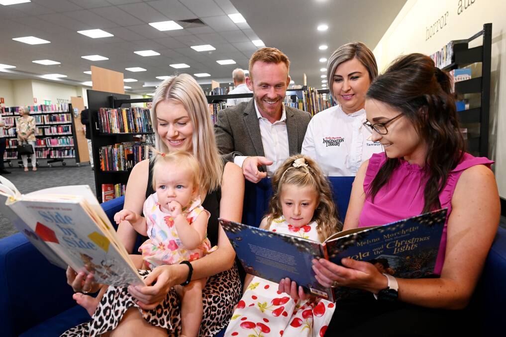 NSW Law Society president Brett McGrath and Tamworth Regional Council's program ambassador, Lisa Rennie share some reading time with (front left) Natalie Graham and Lilah Cini and Annabelle and Donna Flemming. Picture by Gareth Gardner