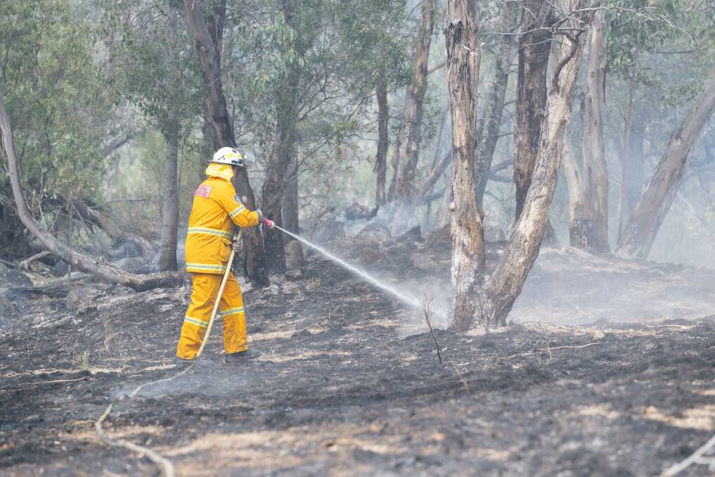 Tamworth Rural Fire Service crews are battling steep terrain with thick bush to fight a bush fire started by a lightning strike in Splitters Gully Road, at Moonbi. Pictures by Peter HArdin