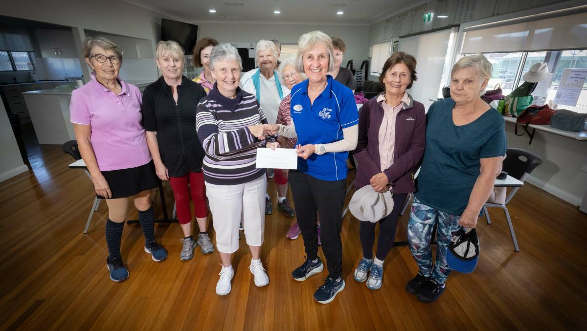 Yvonne Fisher and Leanne Browne (centre front), with other members of the West Tamworth Tennis Club social players' group, and the group's $1000 donation for Tamworth hospital's rehabilitation unit. Picture by Peter Hardin