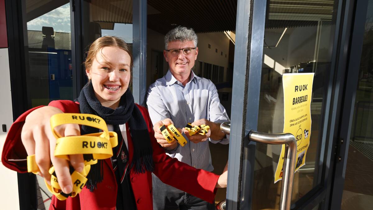 Calrossy Years 7 to 9 school captain, Bronte Gillan, with science teacher Todd McDonald, and the R U OK Day wrist bands that will be handed out to students during the school's first R U OK Day on Wednesday, September 13. Picture by Gareth Gardner