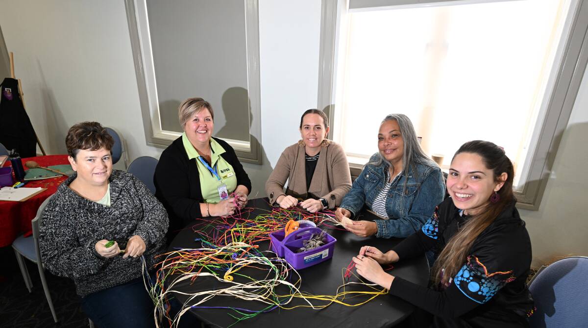 Cathy Miller, Bec Butler, Sara Byrnes, Louise Livermoore and Taylor Williams create traditional woven coils in coloured raffia. Picture Gareth Gardner