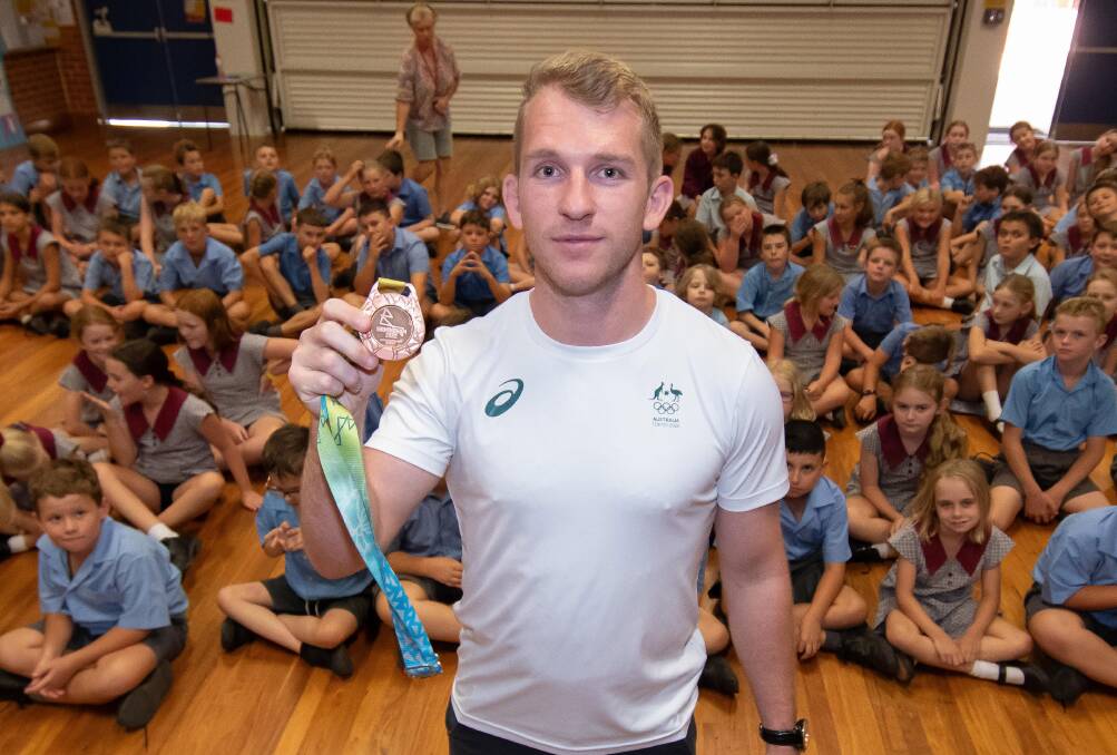 Olympian and Commonwealth Games athlete Nathan Katz, holding his Commonwealth Games bronze medal for judo, inspired a lot of future athletes during his visit to Nemingha Public School. Picture by Peter Hardin 