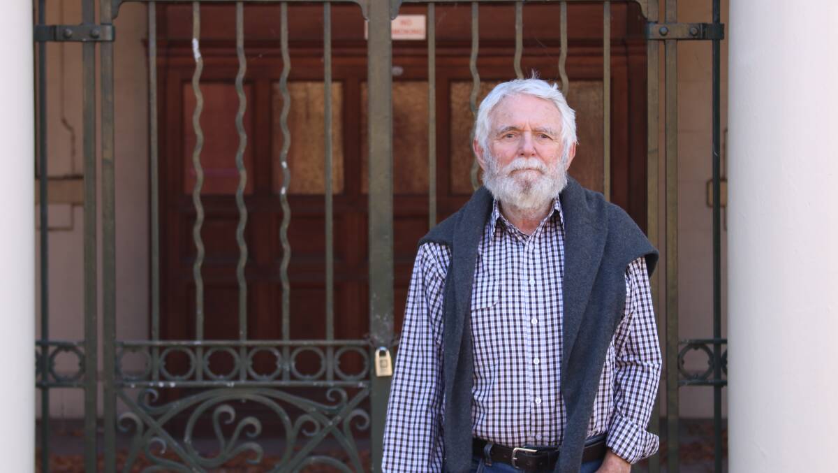 Gordon Cope from the group 'Armidale Live' standing outside the locked old Armidale courthouse in the Beardy Street Mall.