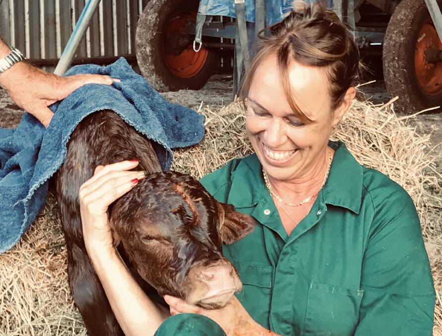 Dr Gundi Rhoades with a calf. Picture supplied 