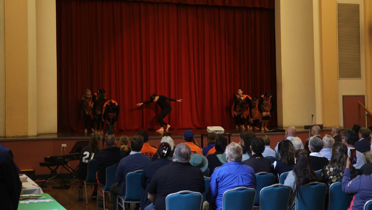 Performers take to the stage at Armidale Town Hall for a breakfast gathering to remember the Armidale tornado. Picture form the Armidale Regional Council Facebook page.