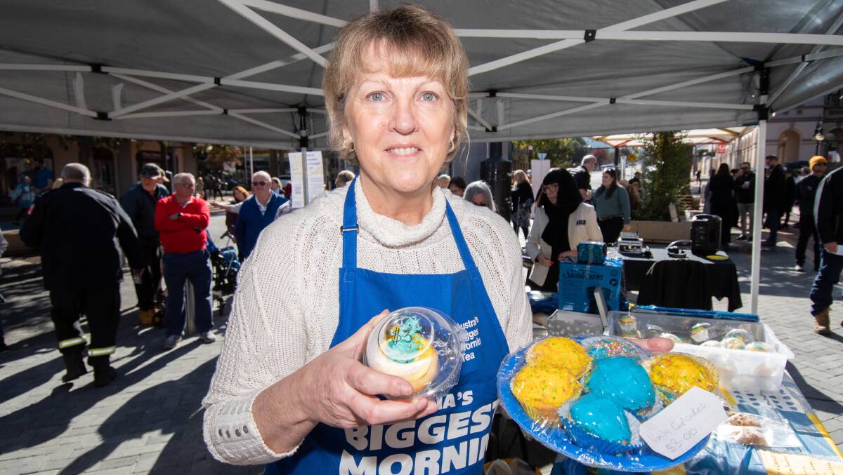 Jolene Alfred serves up a sweet treat or two at Australia's Biggest Morning Tea in Fitzroy Plaza on Thursday morning. Picture by Peter Hardin.