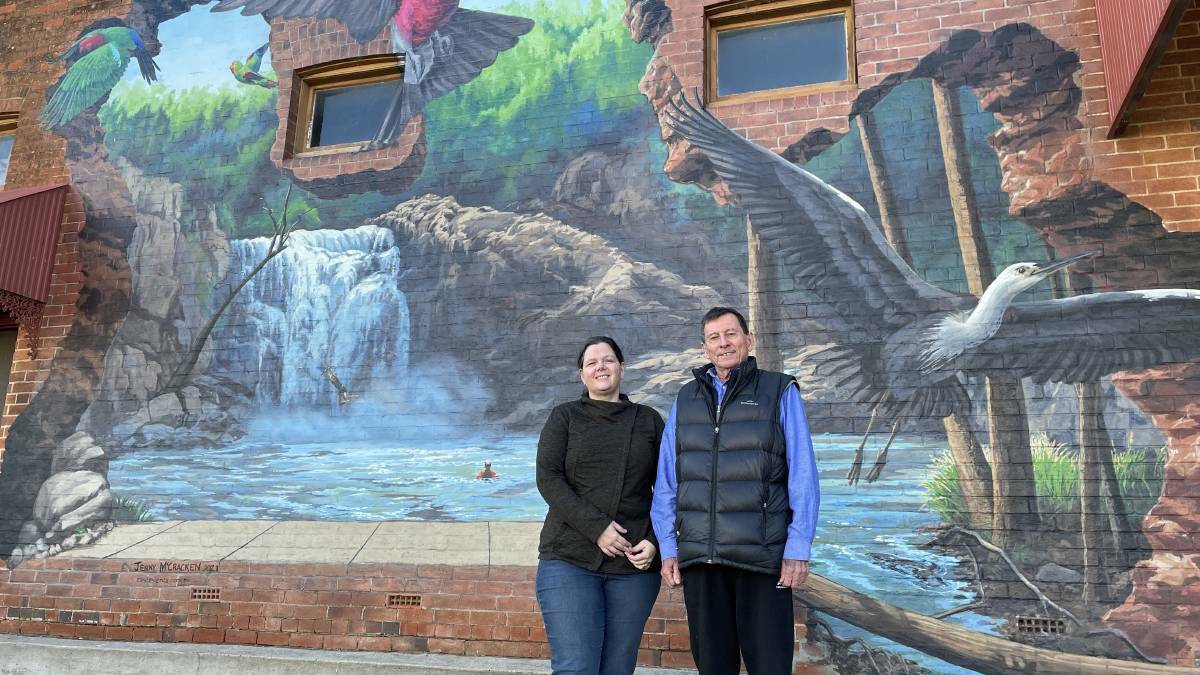 Frost Over Barraba committee members Wendy Woodhouse and Andy Wright outside the historic Treloar's Building with popular mural 'Beyond the Walls'. Picture by NDL