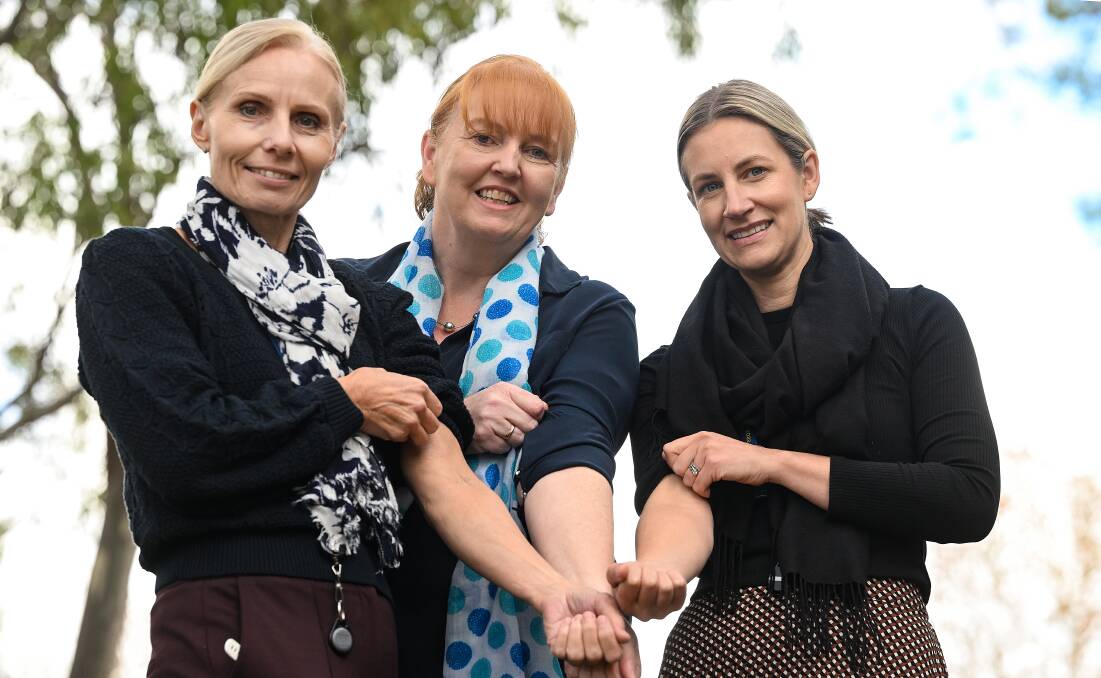 Tracy Nugent (Health and Wellbeing officer), Mags Noonan (Health and Wellbeing Coordinator and Elley McCallum (Injury Management Specialist) roll up their sleeves ahead of the blood challenge. Picture by Gareth Gardner