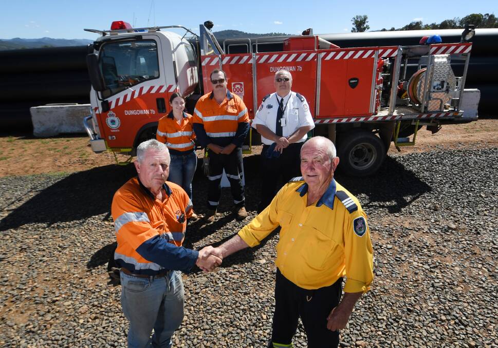 MPC pipeline works Karl Hatfield, Trevor Miles and Tayla Childs with RFS Inspector Stephen Carstons, and Dungowan RFS Captain Jack Hahn to present the fundraising. Picture by Gareth Gardner