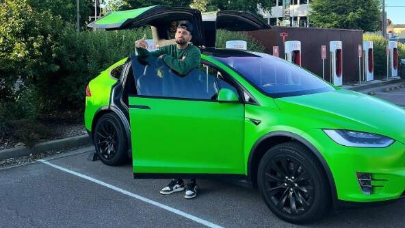 Nick Kyrgios with his Tesla which was stolen at gunpoint last year. Picture Instagram