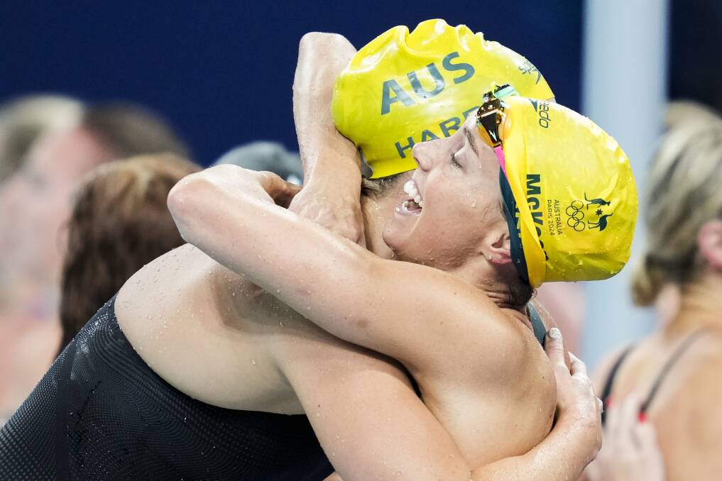 Emma McKeon wraps her arms around lead-off swimmer Mollie O'Callaghan after Australia won the 4x100m freestyle relay at the Paris Olympics. Picture AAP