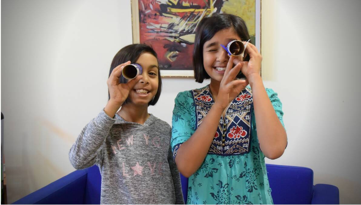 PEEKING THROUGH: Sisters Aasiya Fawaz, 9, and Azkah Fawaz, 11, created a unique perspective on the world. Photo: Carolyn Millet 011019CMA01