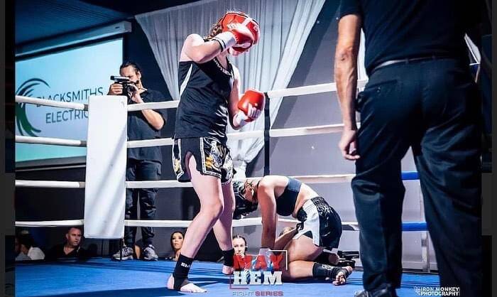 Flemming drops her opponent with a right hook in her last bout. Picture by Iron Monkey Photography