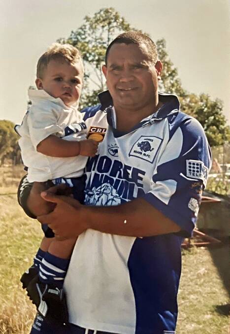 Trevor Tighe nurses Jake after Moree's grand final win over West Lions in 2002. Picture supplied