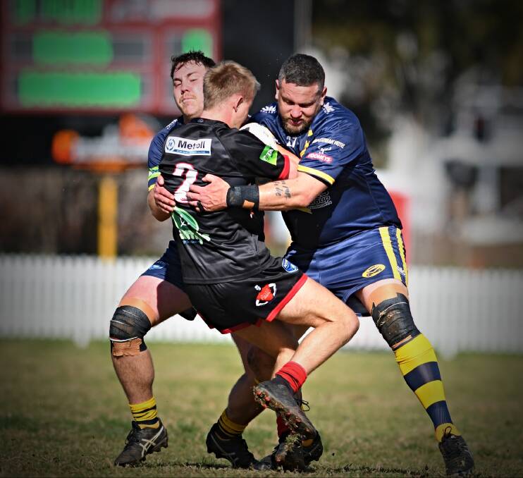 Allwood (right) hammers Bears winger Ashton Constable in the Cowboys' 16-12 major semi-final win at Jack Woolaston Oval. Picture by Mark Bode