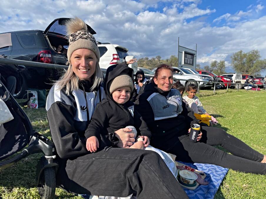 Slater and Khoa have a front-row seat for the clash between the Magpies and the Roos at Werris Creek on Saturday, May 18. Picture by Mark Bode