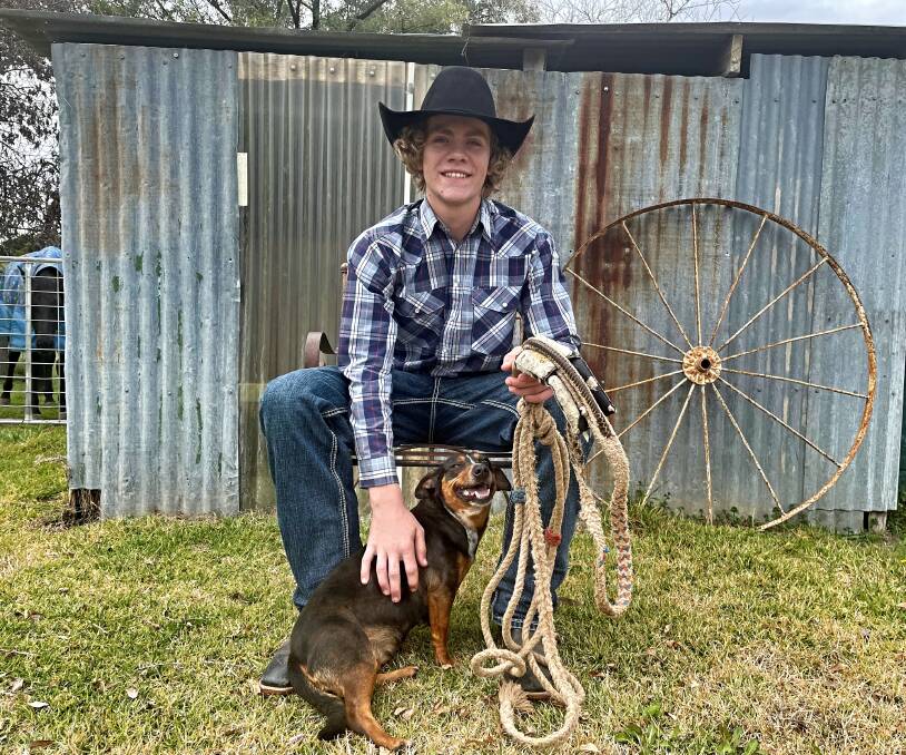 Bull rider Colby Edgar holds his lucky bull rope, and pats his dog Polly, at his family's Warral property on Saturday, July 29. Picture by Mark Bode 
