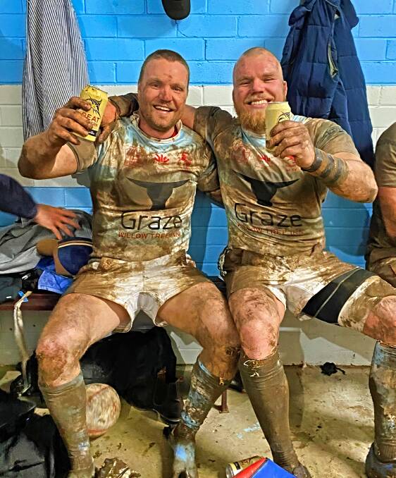 Will and Andy Saunders mark their final game of footy with a beer. Picture supplied