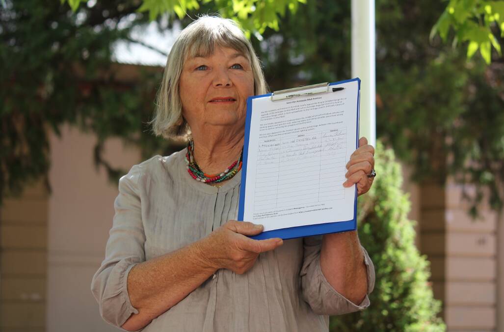 Institute convener and founder Maria Hitchcock (pictured with a different petition) is keen for local leaders to monitor the situation regarding a split in the Hunter New England Local Health District.
