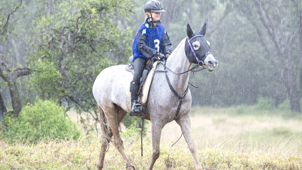 Ruby Grace smiling through the rain in the 160km endurance ride to finish as second junior. Picture by Sarah Sullivan Photography. 