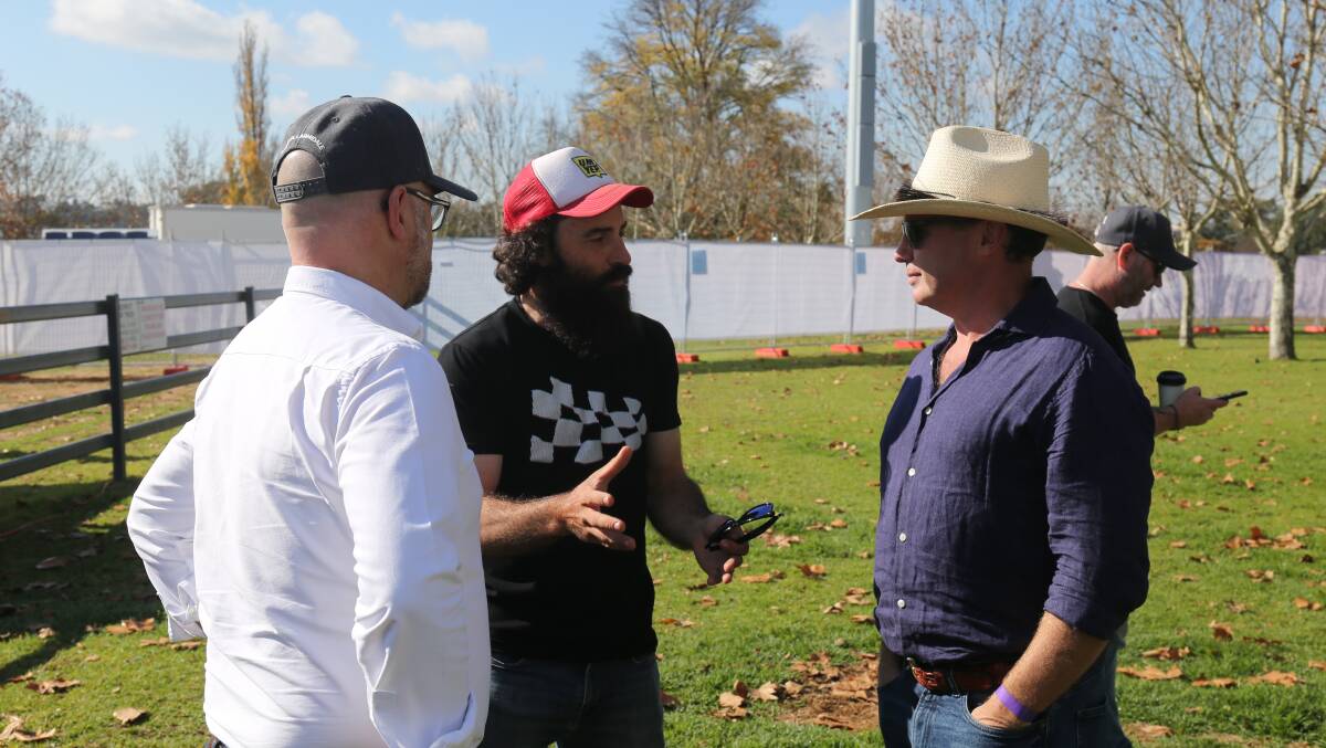 DJ Electric Postman (centre) chats with deputy mayor Todd Redwood and Mayor Sam Coupland on Saturday morning. 
