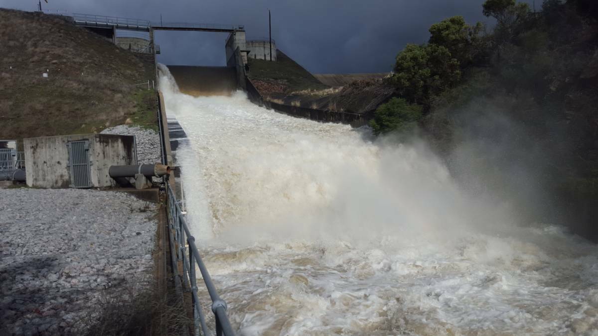 HIGH LEVEL: Dungowan Dam was overflowing after rain earlier in the year, but the level has since dropped. Photo: Peter Hardin