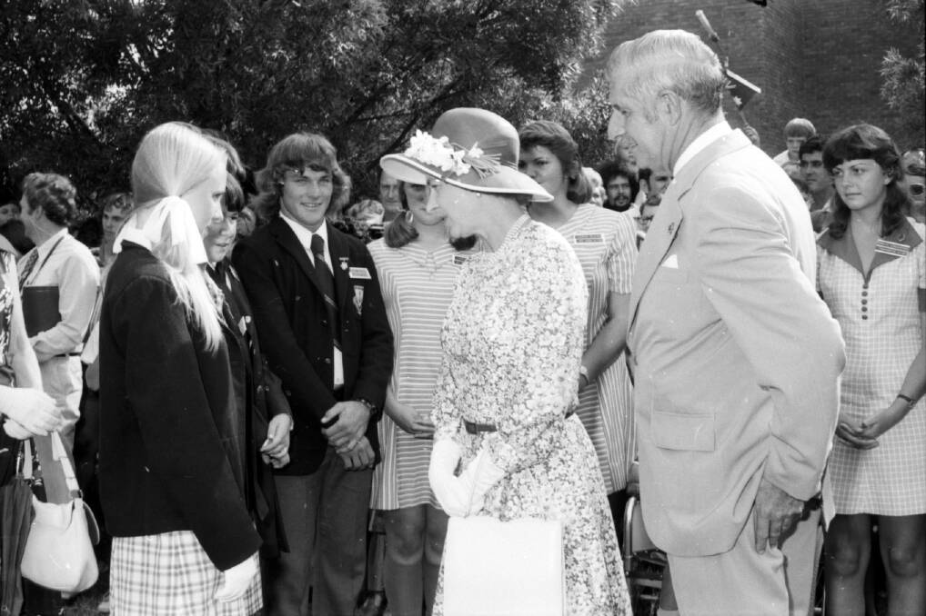 Oxley High School captain Greg Guider watches on as Queen Elizabeth II and Prince Philip meet Tamworth students in 1977. Picture by the Leader
